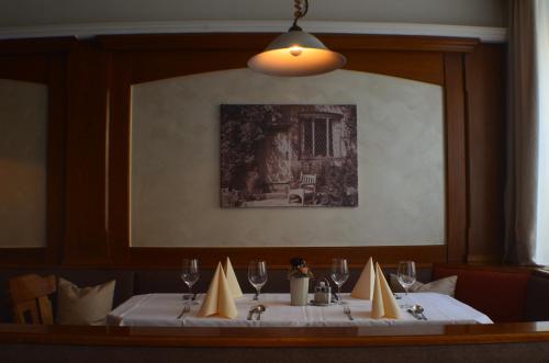 a dining room with a table with a white table cloth at Gasthof Ginzinger in Mauerkirchen