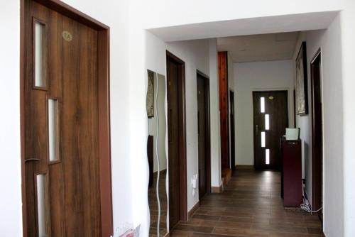a hallway with wooden doors and a hallway with a hallway at Rodinná izba Stummer in Topoľčany