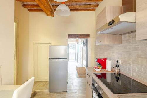 a kitchen with a white refrigerator in a room at The View - Sunset & Relax - Suite - Appartamenti Vista Lago in Passignano sul Trasimeno