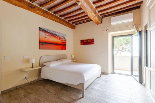 a bedroom with a bed and a large window at The View - Sunset & Relax - Suite - Appartamenti Vista Lago in Passignano sul Trasimeno