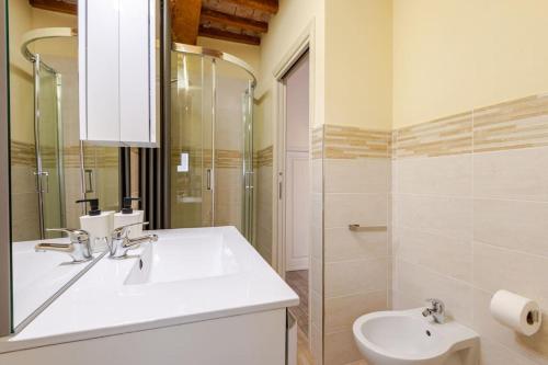 a bathroom with a sink and a toilet and a mirror at The View - Sunset & Relax - Suite - Appartamenti Vista Lago in Passignano sul Trasimeno
