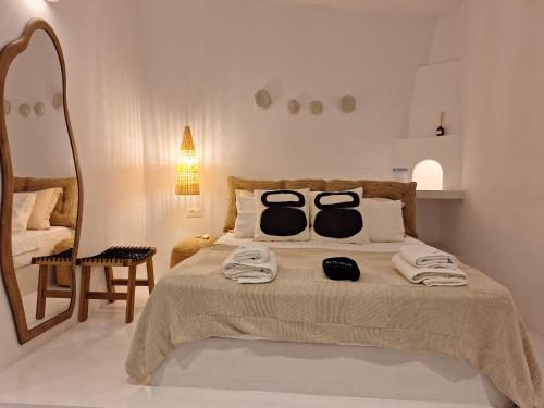 a bedroom with a bed with two towels on it at Pavezzo in Ios Chora