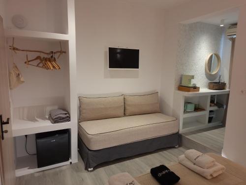 een woonkamer met een bank en een tv bij Pavezzo in Ios Chora