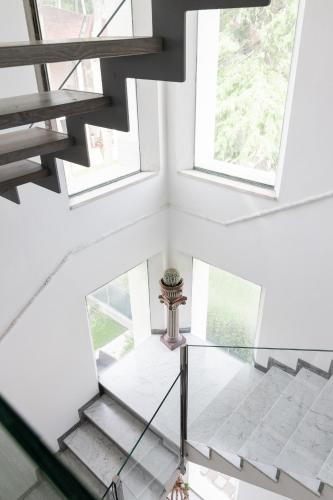 a glass staircase in a house with windows at Villa Liliana in Cervia