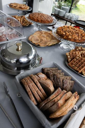 a table with various types of bread and pies at Villa Liliana in Cervia