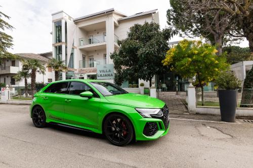 a green car parked in front of a building at Villa Liliana in Cervia