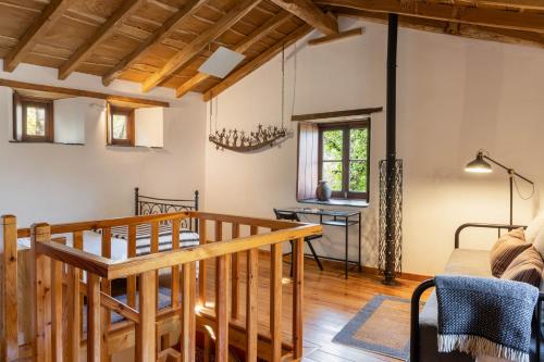 a dining room and living room with a wooden table at Cerdeira - Home for Creativity in Lousã