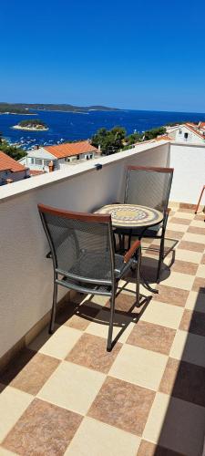 two chairs and a table on a balcony at Apartments Villa Bella Vista Hvar in Hvar