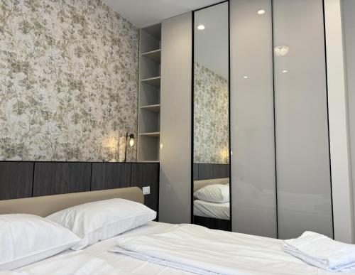 a bedroom with a bed and a mirror at Il Sogno Apartment in Trieste
