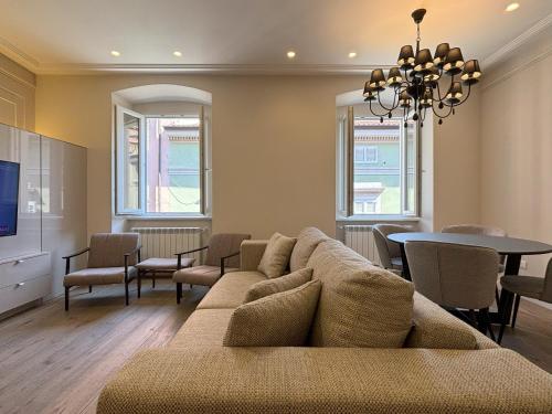 a living room with a couch and a table at Il Sogno Apartment in Trieste