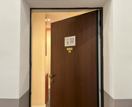 a brown elevator door with a sign on it at Il Sogno Apartment in Trieste