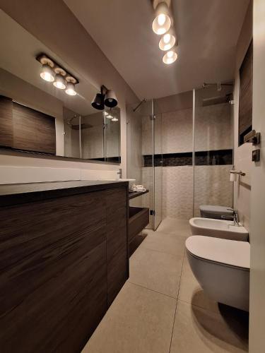a bathroom with a toilet and a sink and mirrors at Panoramic view-Excelent location in Arad