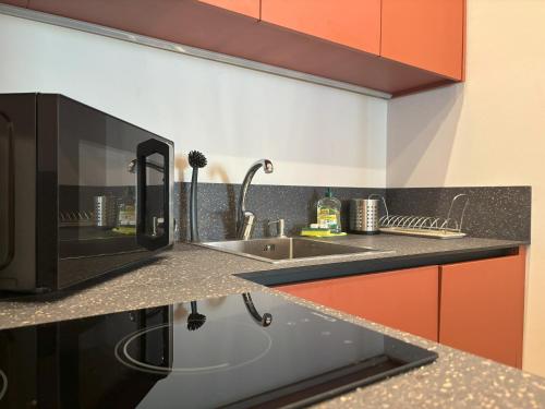 a kitchen with a sink and a microwave at Il Sogno Apartment in Trieste