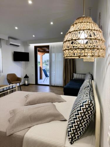 a bedroom with two beds and a chandelier at Afroditi's House studioB4 in Ormos Panagias