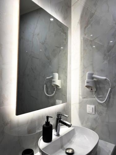 a bathroom with a sink and a mirror at Afroditi's House studioB4 in Ormos Panagias