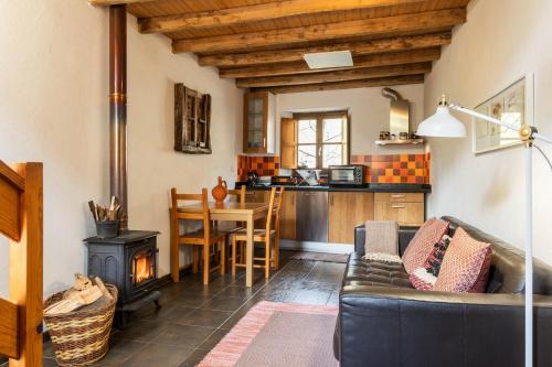 a living room with a couch and a stove at Cerdeira - Home for Creativity in Lousã