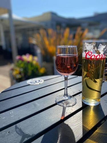 a glass of wine sitting next to a glass of beer at Lakeside East 16 - Haggerston Castle in Berwick-Upon-Tweed