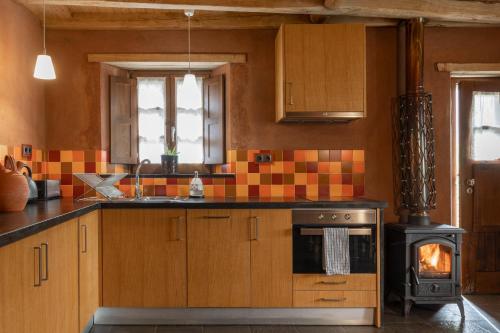 a kitchen with an oven and a stove at Cerdeira - Home for Creativity in Lousã