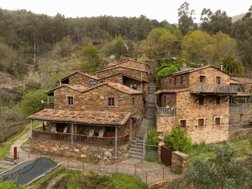a group of old stone houses on a hill at Cerdeira - Home for Creativity in Lousã