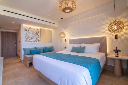 1 dormitorio con 1 cama grande y 1 sofá en Pegasos Deluxe Beach Hotel, en Faliraki