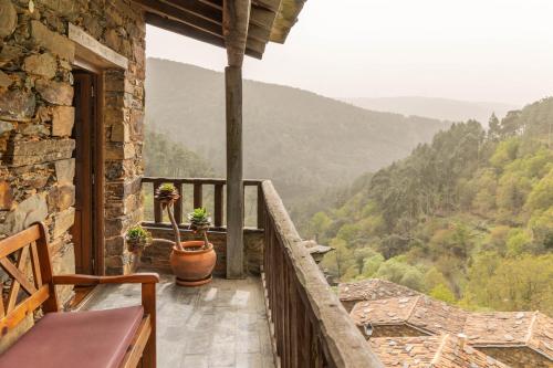 a balcony of a house with a view of the mountains at Cerdeira - Home for Creativity in Lousã