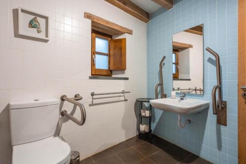 a bathroom with a toilet and a sink at Cerdeira - Home for Creativity in Lousã