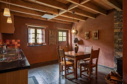 a dining room with a wooden table and chairs at Cerdeira - Home for Creativity in Lousã