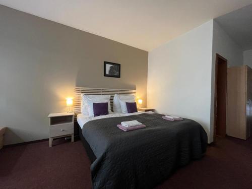 a bedroom with a bed with two towels on it at Ubytování U Pekaře in Děčín