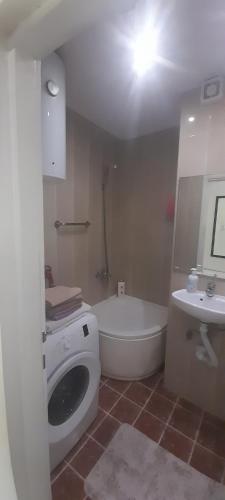 a bathroom with a tub and a toilet and a sink at Stan na dan -Bratunac- in Bratunac