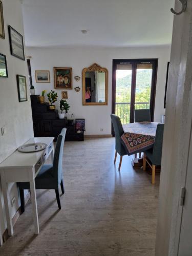 a living room with a dining room table and chairs at Chez Gabrielle in Gaillard