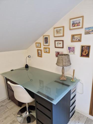 an office with a desk with a lamp and a chair at Chez Gabrielle in Gaillard