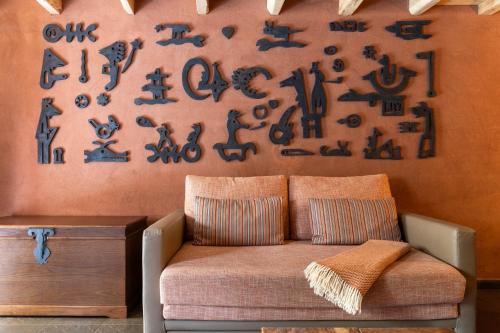a living room with a couch and a wall with signs at Cerdeira - Home for Creativity in Lousã