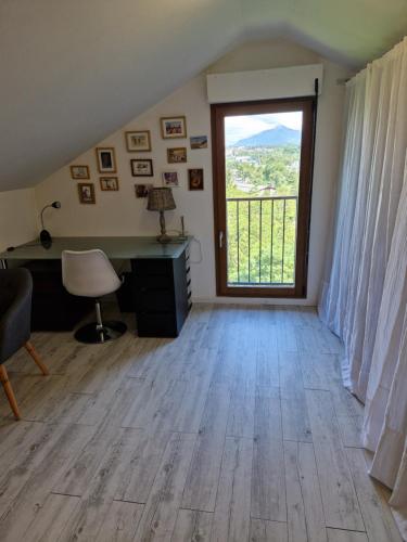 a room with a desk and a large window at Chez Gabrielle in Gaillard