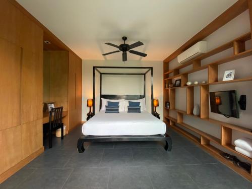 邦濤海灘的住宿－Three Bedroom Wings Pool Villa，一间卧室配有一张床和吊扇