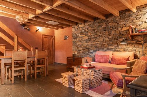a living room with a couch and a table at Cerdeira - Home for Creativity in Lousã