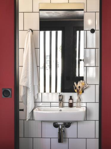 a bathroom with a sink and a mirror at Eklo Toulouse in Toulouse