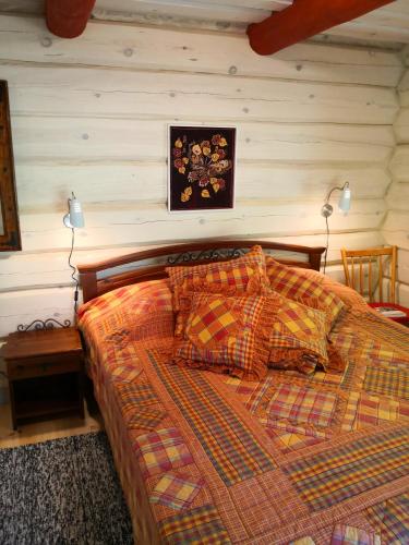 a bedroom with a bed with a checkered blanket at Kotka Farm in Saareküla