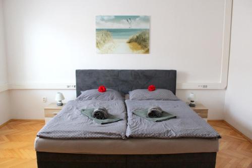 a bedroom with a bed with red bows on it at Rodinná izba Stummer in Topoľčany