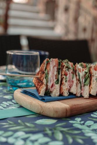 a sandwich on a cutting board on a table at B&B La Corte in Chioggia