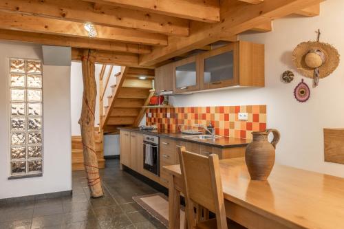 a kitchen with a wooden table and a vase at Cerdeira - Home for Creativity in Lousã