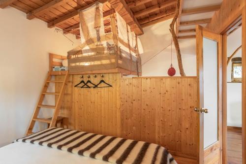 a room with a ladder and a chandelier at Cerdeira - Home for Creativity in Lousã