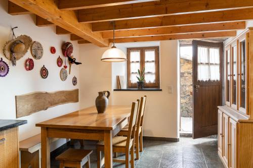 a dining room with a wooden table and chairs at Cerdeira - Home for Creativity in Lousã