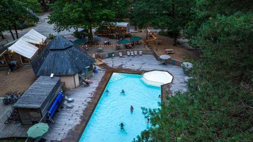 an overhead view of a swimming pool at a resort at Huttopia Lac de Sillé in Sillé-le-Guillaume