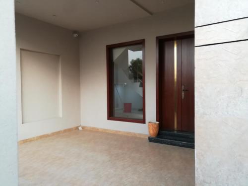 an empty room with a door and a window at Maskan in Islamabad