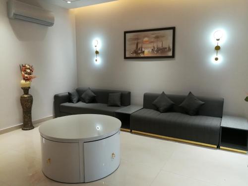 a living room with two couches and a coffee table at Maskan in Islamabad