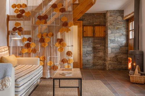 a living room with a couch and a fireplace at Cerdeira - Home for Creativity in Lousã