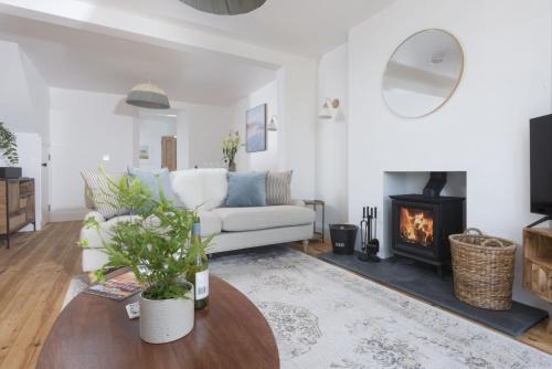 a living room with a couch and a fireplace at 11 Tywarnhayle House, Perranporth in Perranporth