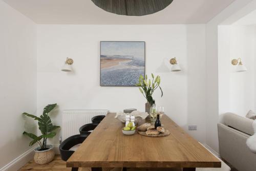 a living room with a wooden table and a couch at 11 Tywarnhayle House, Perranporth in Perranporth