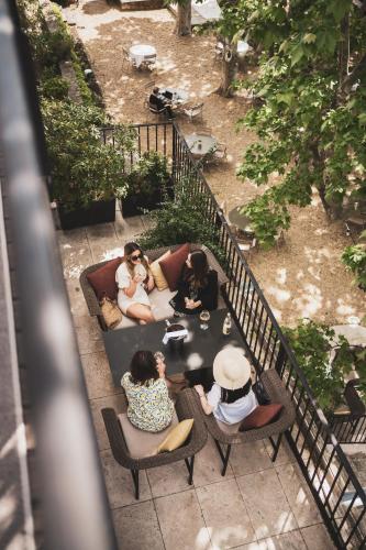 a group of people sitting around a table at Les Lodges Sainte-Victoire Hotel & Spa in Aix-en-Provence