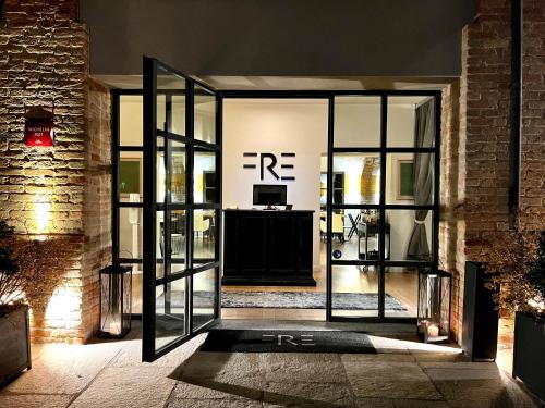 an open entrance to a room with glass doors at Réva Residences and Pool in Monforte dʼAlba